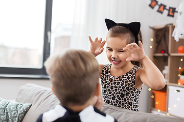 Image showing kids in halloween costumes playing at home