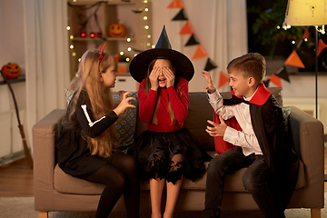 Image showing kids in halloween costumes playing at home