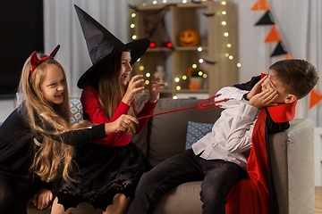 Image showing kids in halloween costumes playing at home