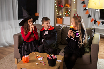 Image showing kids in halloween costumes playing at home