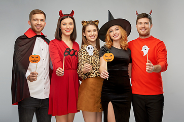 Image showing friends in halloween costumes with party props