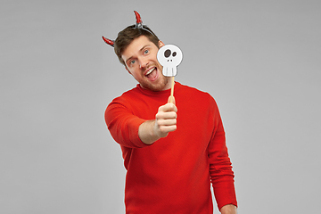 Image showing happy man in halloween costume of devil over grey