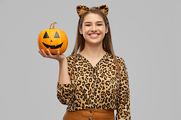 Image showing woman in halloween costume of leopard with pumpkin