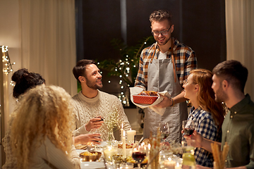 Image showing happy friends having christmas dinner at home