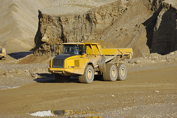 Image showing A yellow dump truck is working