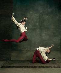 Image showing Two young female ballet dancers like duelists with swords. Ballet and contemporary choreography concept. Creative art photo.