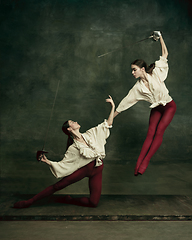 Image showing Two young female ballet dancers like duelists with swords. Ballet and contemporary choreography concept. Creative art photo.