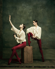 Image showing Two young female ballet dancers like duelists with swords. Ballet and contemporary choreography concept. Creative art photo.