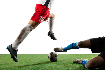 Image showing Close up legs of professional soccer, football players fighting for ball on field isolated on white background