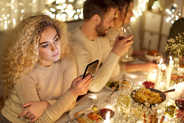 Image showing woman with smartphone at dinner party with friends