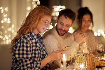 Image showing friends with cellphone having dinner party at home