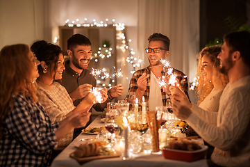 Image showing happy friends having christmas dinner at home