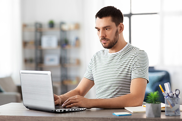 Image showing man with laptop working at home office