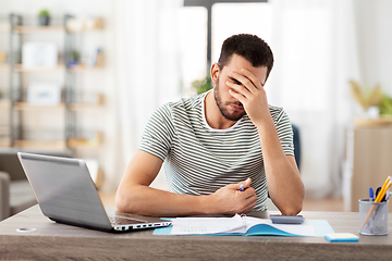 Image showing man with files and calculator works at home office