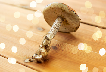 Image showing brown cap boletus mushrooms on wooden background