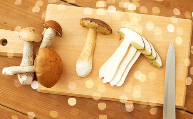 Image showing edible mushrooms, kitchen knife and cutting board