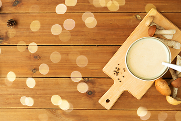 Image showing mushroom cream soup in bowl on cutting board