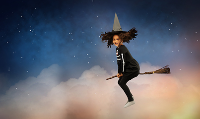 Image showing girl in black witch hat with broom on halloween