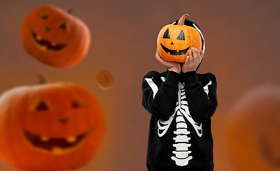 Image showing boy in halloween costume with jack-o-lantern