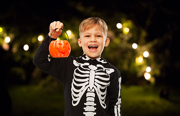 Image showing happy boy in halloween costume with jack-o-lantern