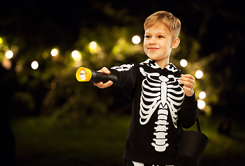 Image showing happy with candies and flashlight on halloween