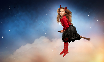 Image showing girl in halloween costume flying on witch's broom