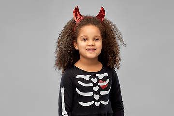 Image showing girl in black dress and devil's horns on halloween