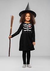 Image showing girl in black witch hat with broom on halloween