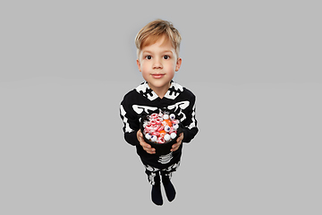 Image showing boy with candies trick-or-treating on halloween