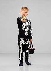 Image showing boy with candies and flashlight on halloween