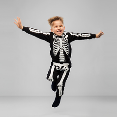 Image showing happy boy in halloween costume of skeleton jumping