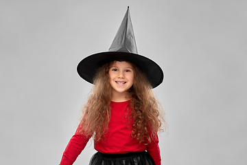 Image showing happy girl in black witch hat on halloween