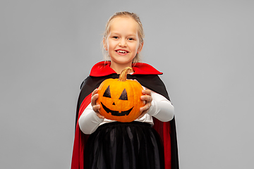 Image showing girl in halloween costume of dracula with pumpkin