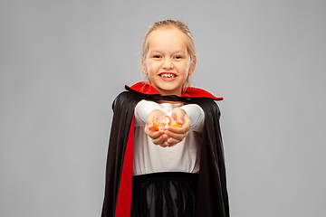 Image showing girl in halloween costume of dracula with candies