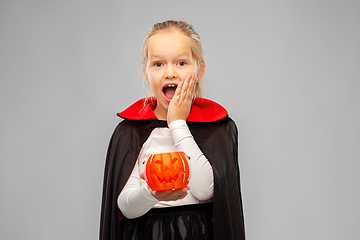 Image showing girl in halloween costume of dracula with pumpkin