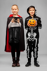 Image showing happy children in halloween costumes with candies