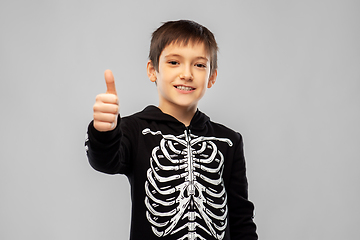 Image showing boy in halloween skeleton costume shows thumbs up