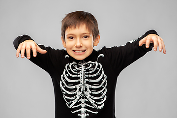 Image showing boy in halloween costume of skeleton frightening