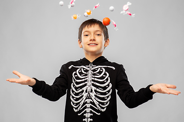 Image showing boy in halloween costume of skeleton with candies