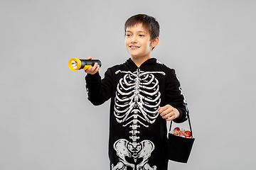 Image showing boy in halloween costume with candies and torch