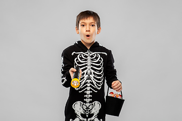 Image showing boy in halloween costume with candies and torch