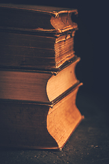 Image showing Stack of antique leather bound books against dark background