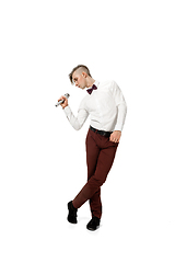 Image showing Happy young man dancing in casual clothes or suit, remaking legendary moves of celebrity from culture history