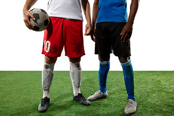 Image showing Close up legs of professional soccer, football players fighting for ball on field isolated on white background