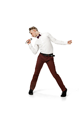 Image showing Happy young man dancing in casual clothes or suit, remaking legendary moves of celebrity from culture history