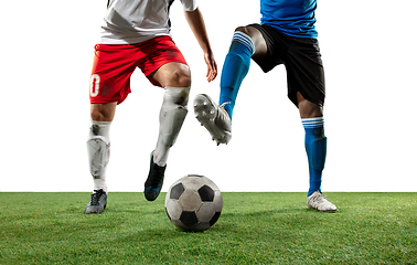 Image showing Close up legs of professional soccer, football players fighting for ball on field isolated on white background