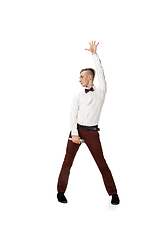 Image showing Happy young man dancing in casual clothes or suit, remaking legendary moves of celebrity from culture history