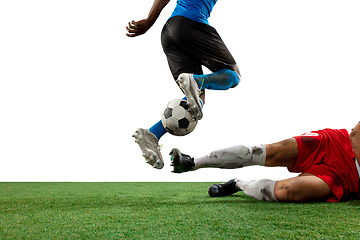Image showing Close up legs of professional soccer, football players fighting for ball on field isolated on white background