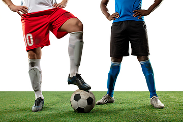 Image showing Close up legs of professional soccer, football players fighting for ball on field isolated on white background