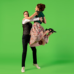 Image showing Old-school fashioned young woman dancing isolated on green background